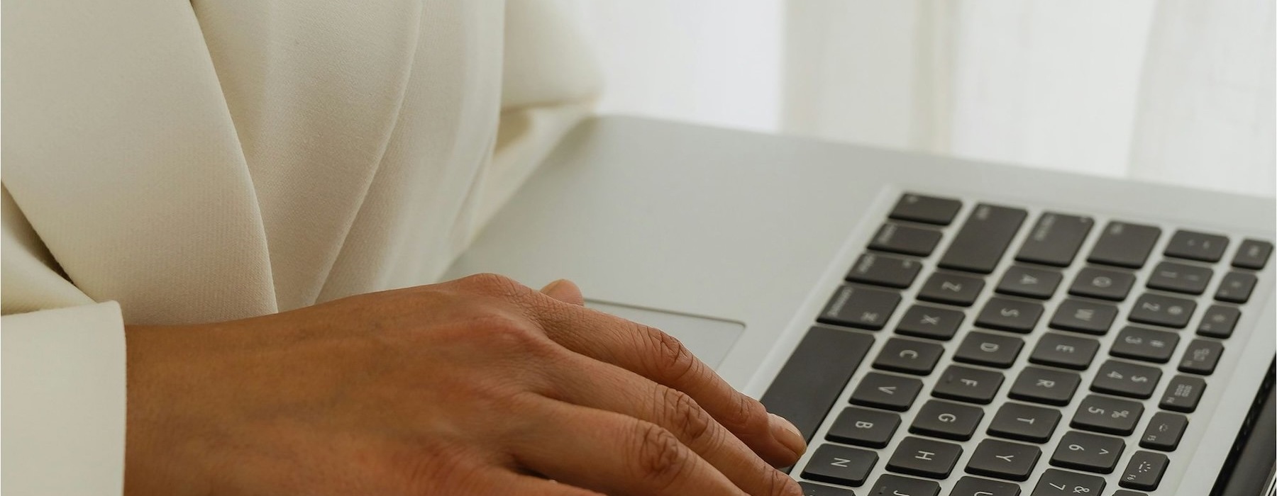A person typing on a laptop at Reflections apartments for rent in Johnson County, KS.