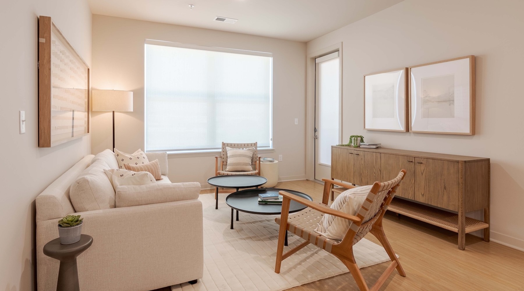 a living room with a couch, chairs and a coffee table